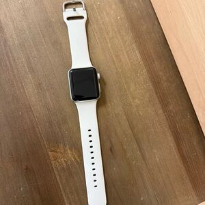 Apple Watch Series 3 with white band and charger.